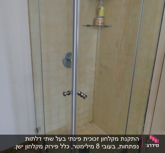 מקלחון זכוכית עם מדף ומוצרי רחצה